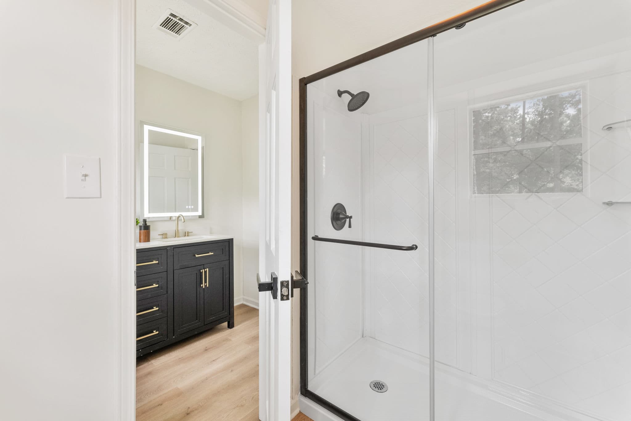 After: new glass shower with matte black fixtures